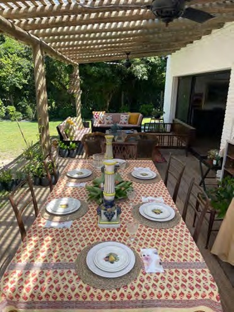 Alfresco dining table set under a wooden pergola