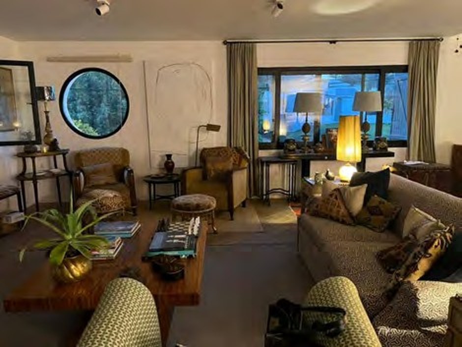 First floor living room with high ceilings, ceiling fan and huge windows